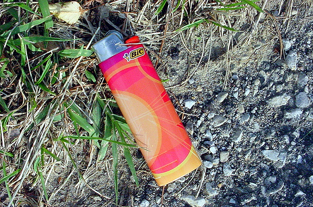 A Bic lighter laying on the ground.