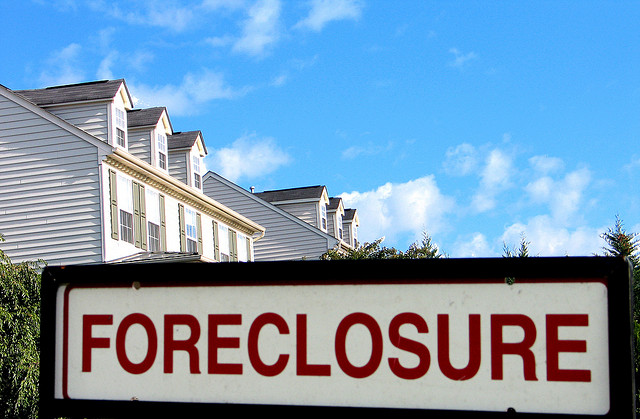 A Foreclosure sign in front of a house.