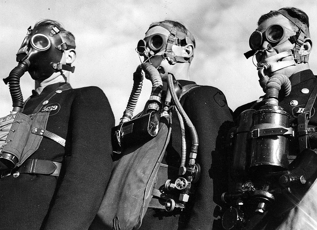 Men wearing gas masks and protective clothing