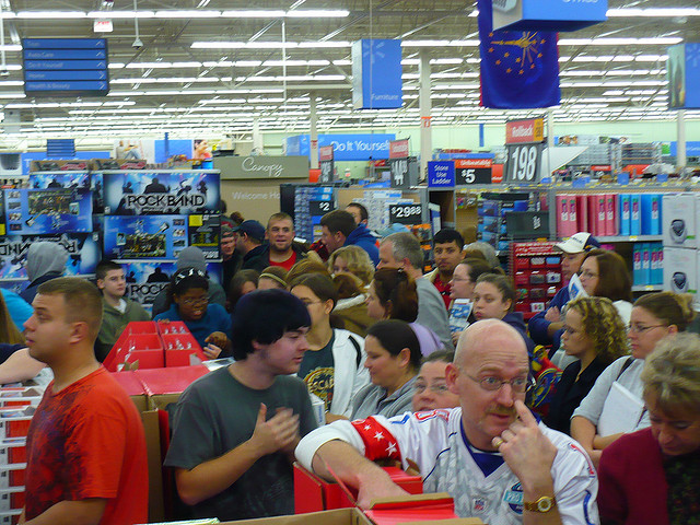 A picture of the chaos of Walmart on Black Friday. Customers everywhere in disordered lines, waiting to check out.