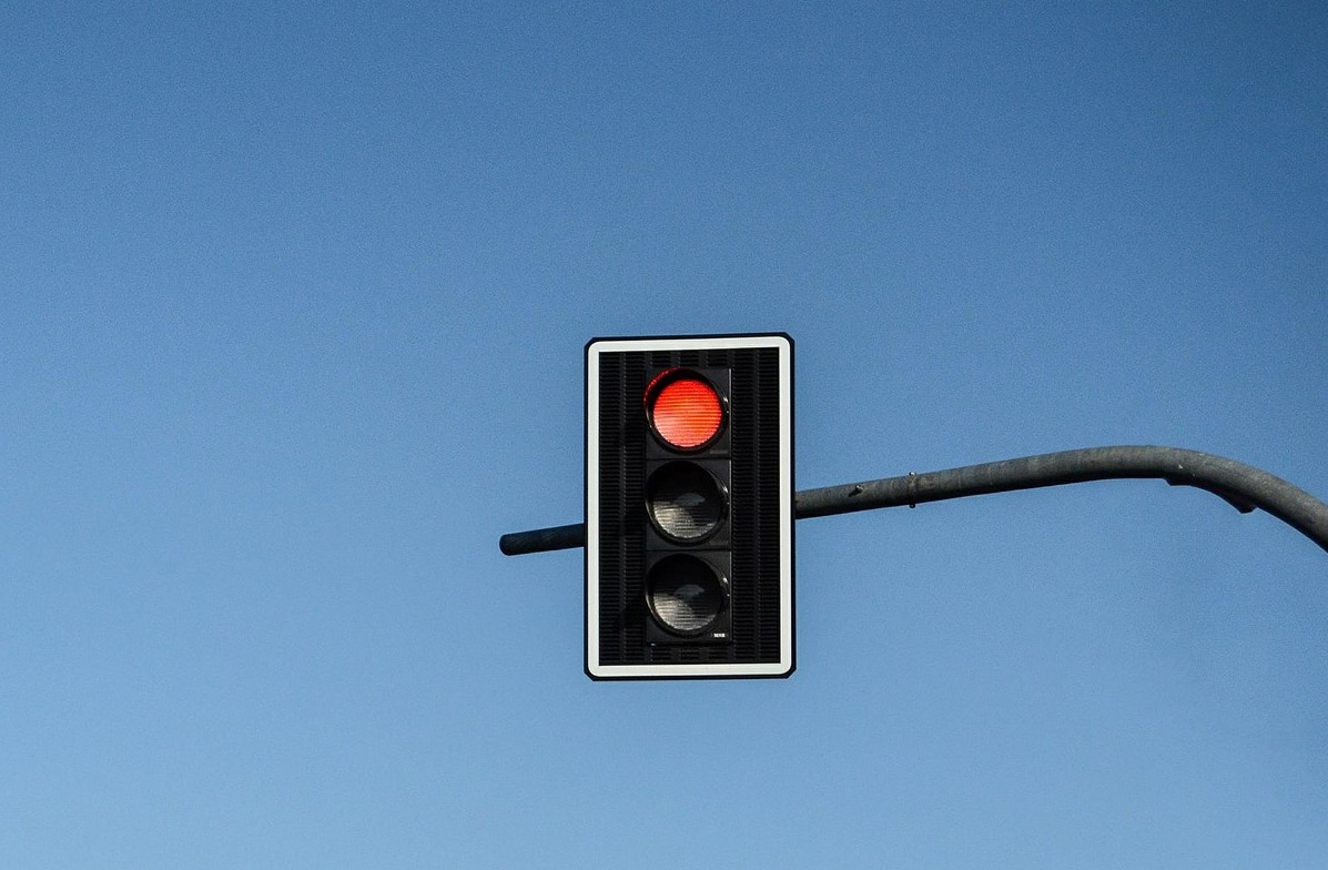 A stoplight with the red stop sign