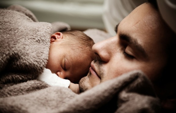 Picture of a baby and his father sleeping