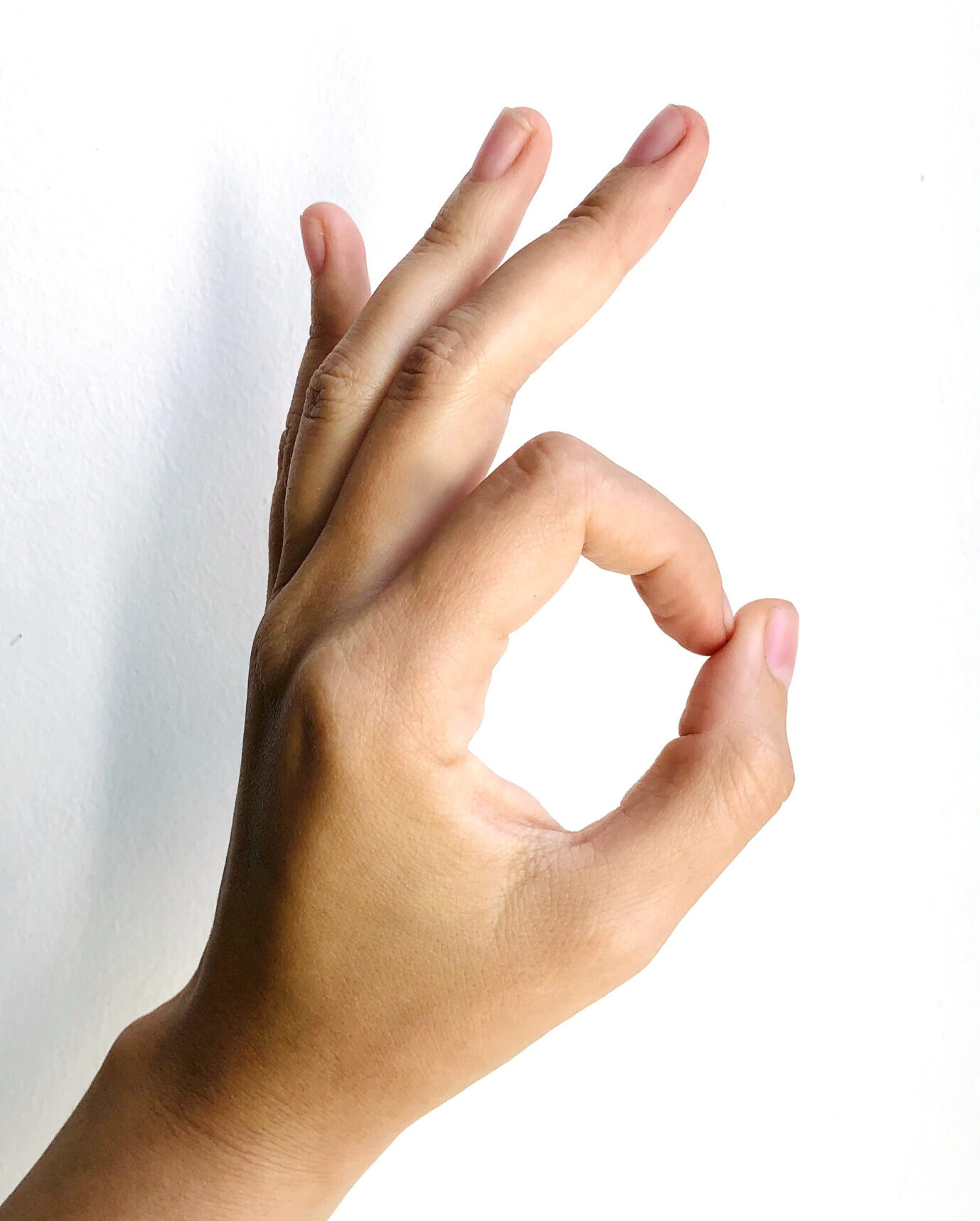 Hand making "OK" gesture