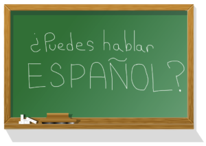 A green chalkboard that asks "Can you speak Spanish? ¿Puedes hablar español?"